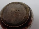 a close up of a metal object on a white surface
