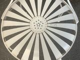an image of a white metal chair on a sidewalk