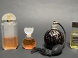 three bottles of perfume sitting next to each other on a table