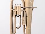 a brass instrument that is sitting on a stand