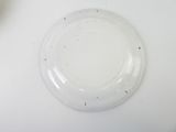 a white plate with a small amount of dirt on it