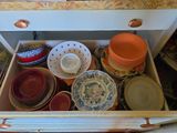 a drawer full of plates and bowls in the kitchen