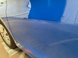 a close up of a blue car that has been painted