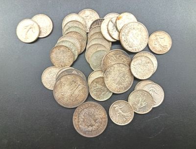 a pile of silver coins on a black surface