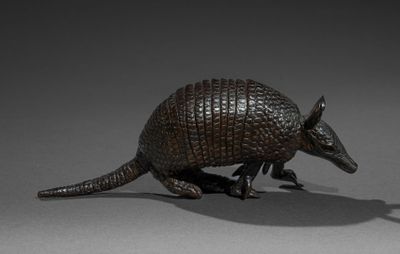 statue of an armadion on a gray surface