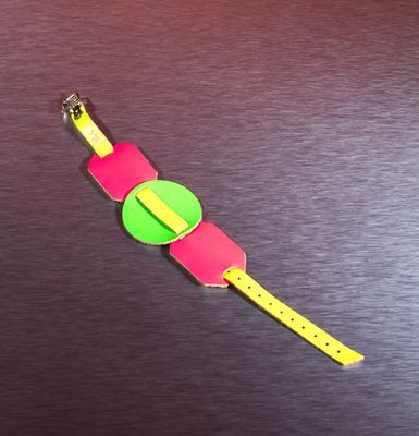 a pink and green watch with a yellow band on it