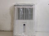 a small air conditioner sitting on the floor next to a wall