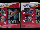 two boxed boxes of pokemon toys are shown on a black background