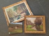 three framed paintings of trees and a house on a table