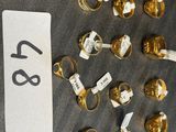 a lot of gold rings that are on a bulletin board