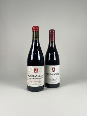 two bottles of red wine sitting next to each other on a table
