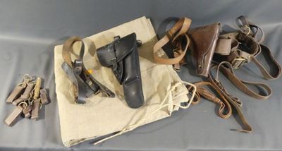 several pairs of leather shoes are laid out on a cloth bag