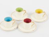 four cups and saucers are sitting on a white surface
