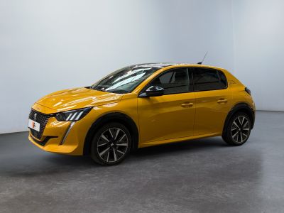 a yellow car parked in a room with a white wall