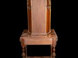 a wooden chair that is sitting on a small table