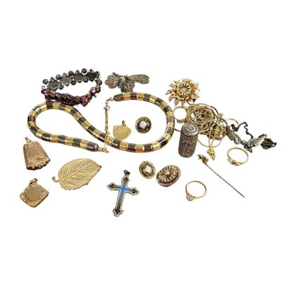 an assortment of jewelry including a cross, a necklace, and other items