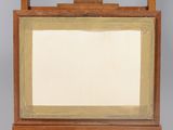 an old wooden easel with a mirror on top of it