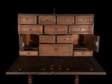 a wooden table with a bunch of drawers on top of it