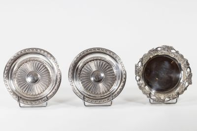 three silver plated objects on a white surface with a white background