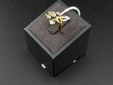 a small black box with a gold ring on top of it