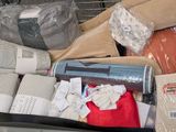 a pile of items in a shopping cart that is full of items