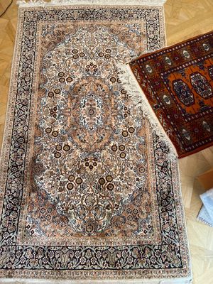 un tapis posé à même le sol, à côté d'un autre tapis posé à même le sol