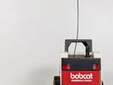 a robot that is sitting next to a remote control