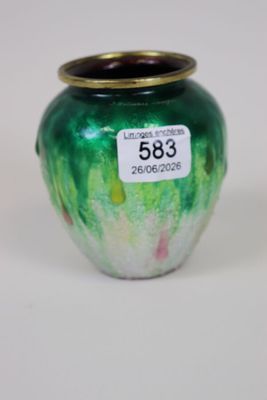 a green vase with a gold rim on a white surface