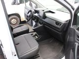 the interior of a car with the door open and the driver ' s seat down