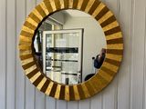 a mirror that is hanging on a wall in a room