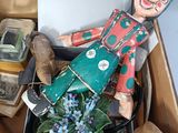 a wooden doll sitting in a box on a table