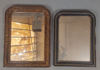 two mirrors hanging on the wall next to each other