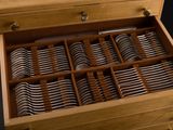 a wooden box filled with silverware on a black background