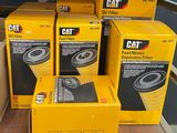 several boxes of cat oil filters stacked on top of each other