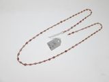 a close up of a necklace with a tag attached to it
