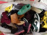 many pairs of shoes in a basket on a table