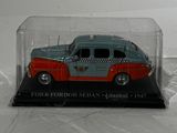 a toy car in a glass case on a white surface