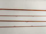 four different types of fishing rods hanging on a wall in a room