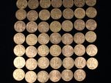 a lot of coins that are on a black surface