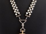 a close up of a necklace on a mannequin mannequin