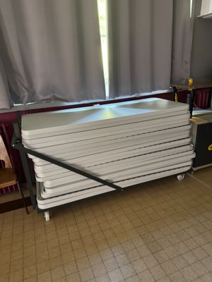 a stack of white plates sitting on top of a table
