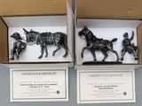 three figurines of horses in a box on a table