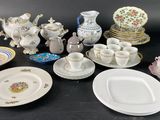 many plates and cups and saucers on the table