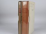 an old book sitting on top of a white table