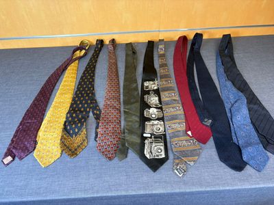 many ties that are lined up on a table