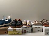 several pairs of shoes sitting on top of boxes on a table
