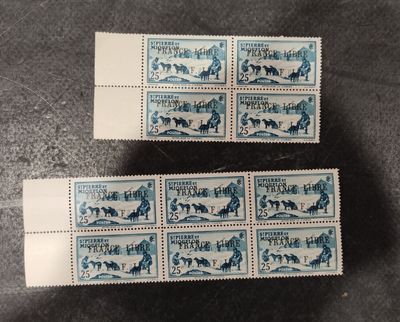 a couple of stamps sitting on top of a table next to each other