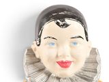 a figurine of a woman wearing a black and white dress