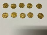 a close up of a bunch of gold coins sitting on top of a table