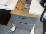 a desk with a telephone, a phone, and papers on it